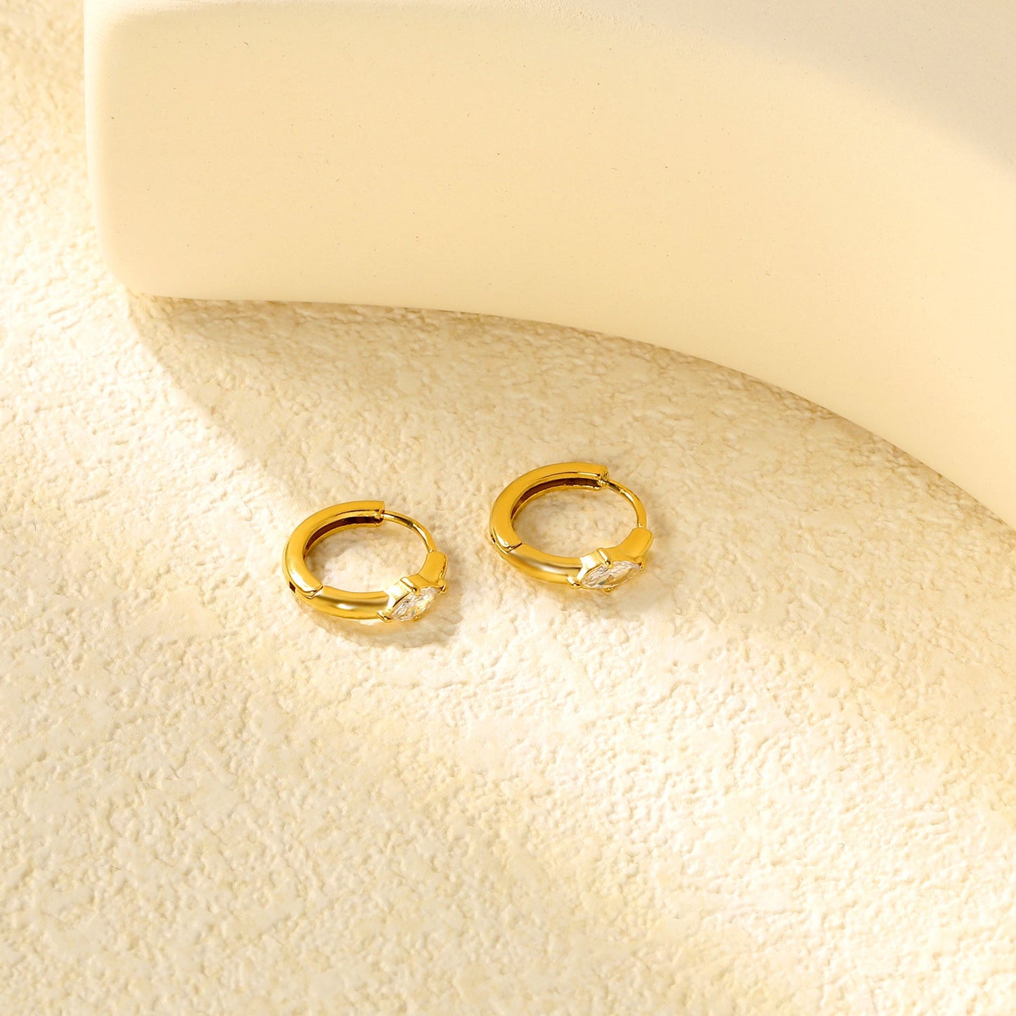 3.7 x 6.7mm diamond-shaped white zirconia stud earrings with a 2.2mm post and a 10mm inner diameter, gold-colored