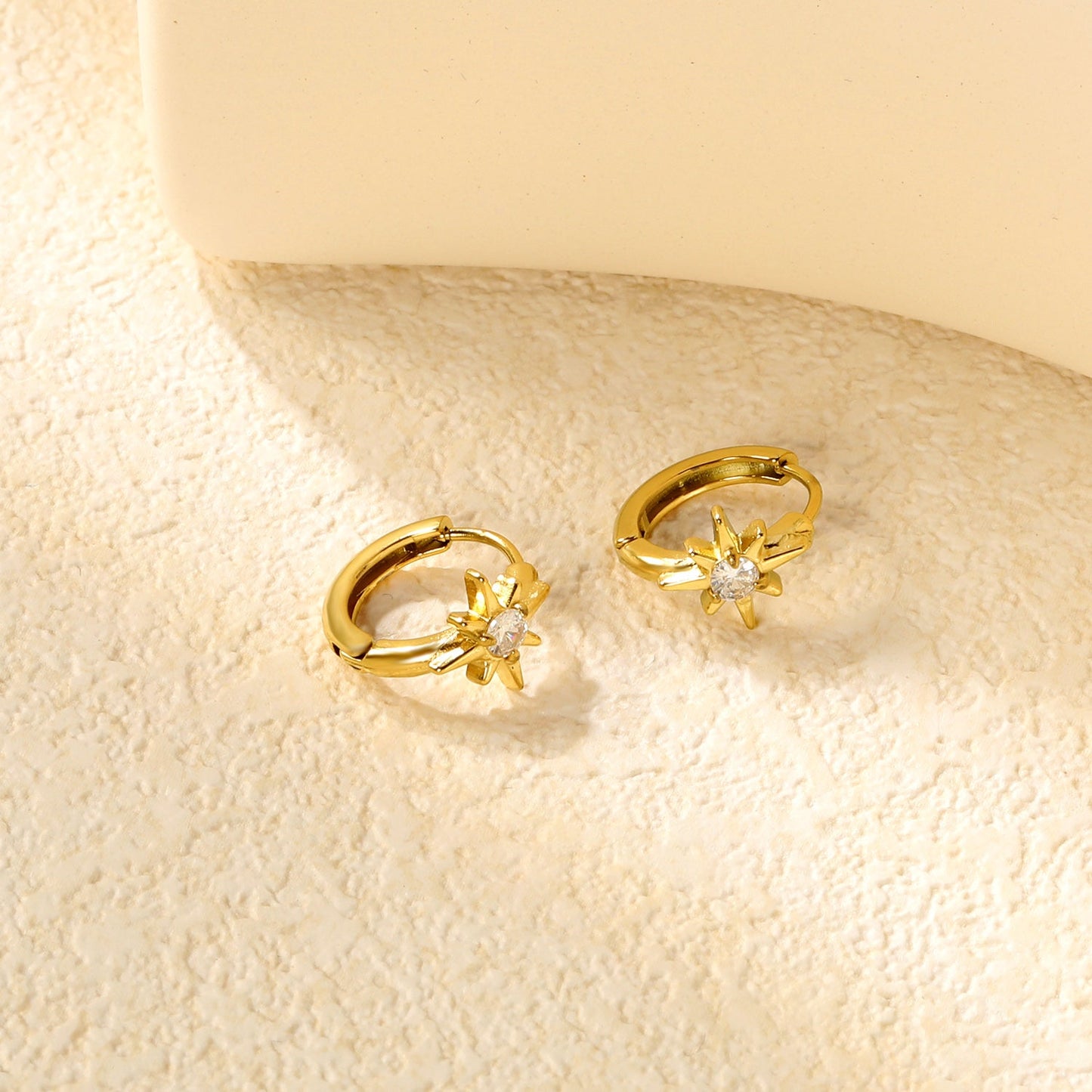 8.9 x 9.6mm eight-pointed star with white zirconia earring with 2.2mm earring post and 10mm inner diameter, gold-colored