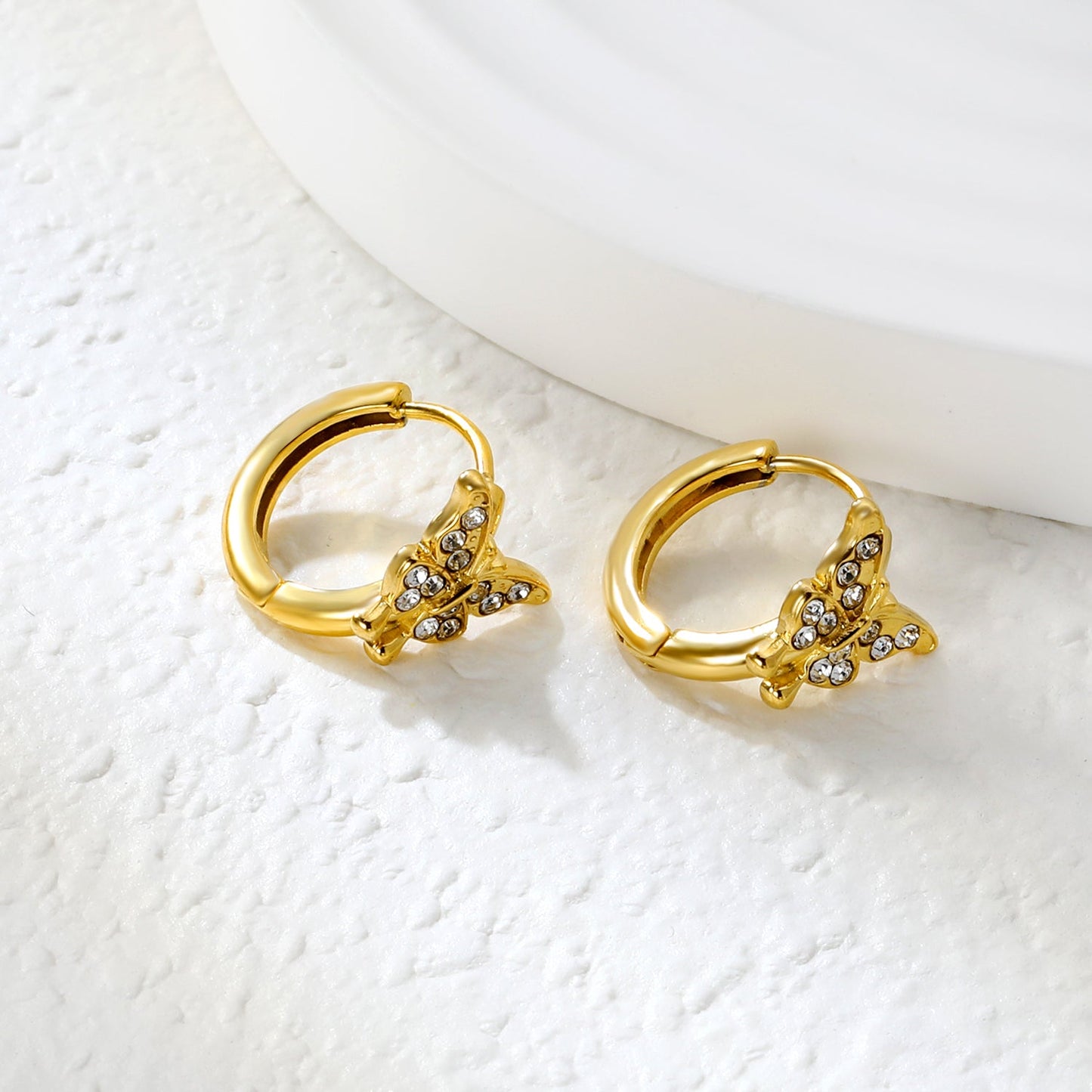 10.3 x 8.8mm butterfly-shaped white zirconia earring with a 2.2mm earring post and a 10mm inner diameter, gold-colored