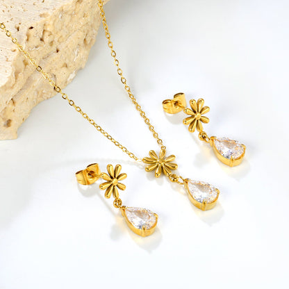 Flower + drop white diamond set Steel / Gold Earrings: 8.3mm flower + 6.2*10mm drop white diamond Pendant: 8.9mm flower + 6.2*10mm drop white diamond 0.3 Cross chain 42+5cm+6mm round plate