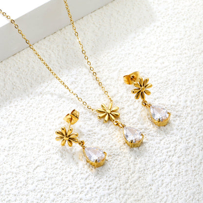 Flower + drop white diamond set Steel / Gold Earrings: 8.3mm flower + 6.2*10mm drop white diamond Pendant: 8.9mm flower + 6.2*10mm drop white diamond 0.3 Cross chain 42+5cm+6mm round plate