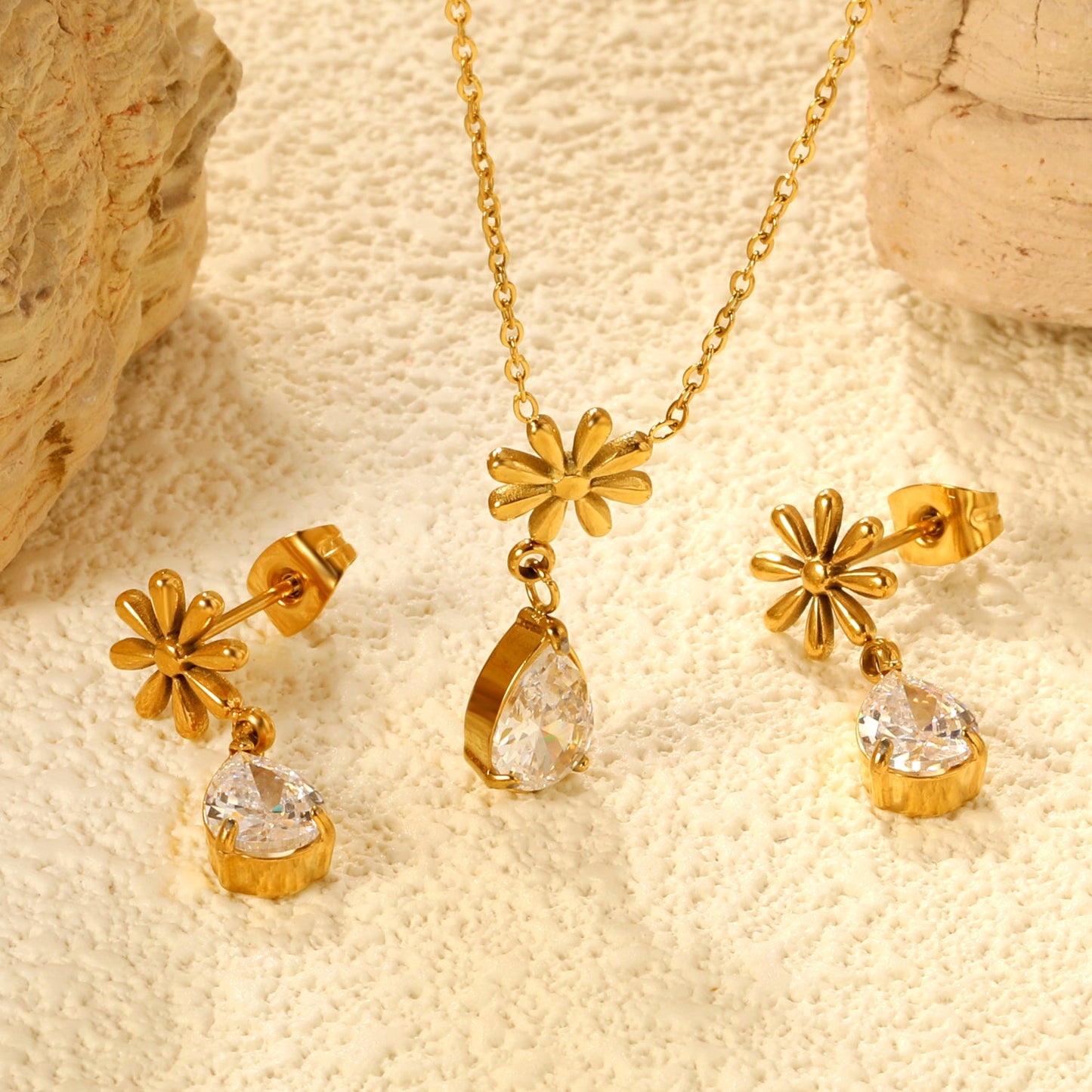 Flower + drop white diamond set Steel / Gold Earrings: 8.3mm flower + 6.2*10mm drop white diamond Pendant: 8.9mm flower + 6.2*10mm drop white diamond 0.3 Cross chain 42+5cm+6mm round plate